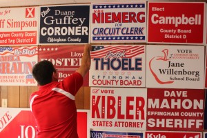 Effingham County Republican Chairman Rob Arnold post campaign signs.