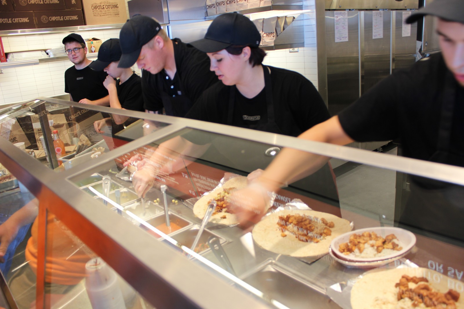 Chipotle team member serve the first customers at the newly opened restaurant