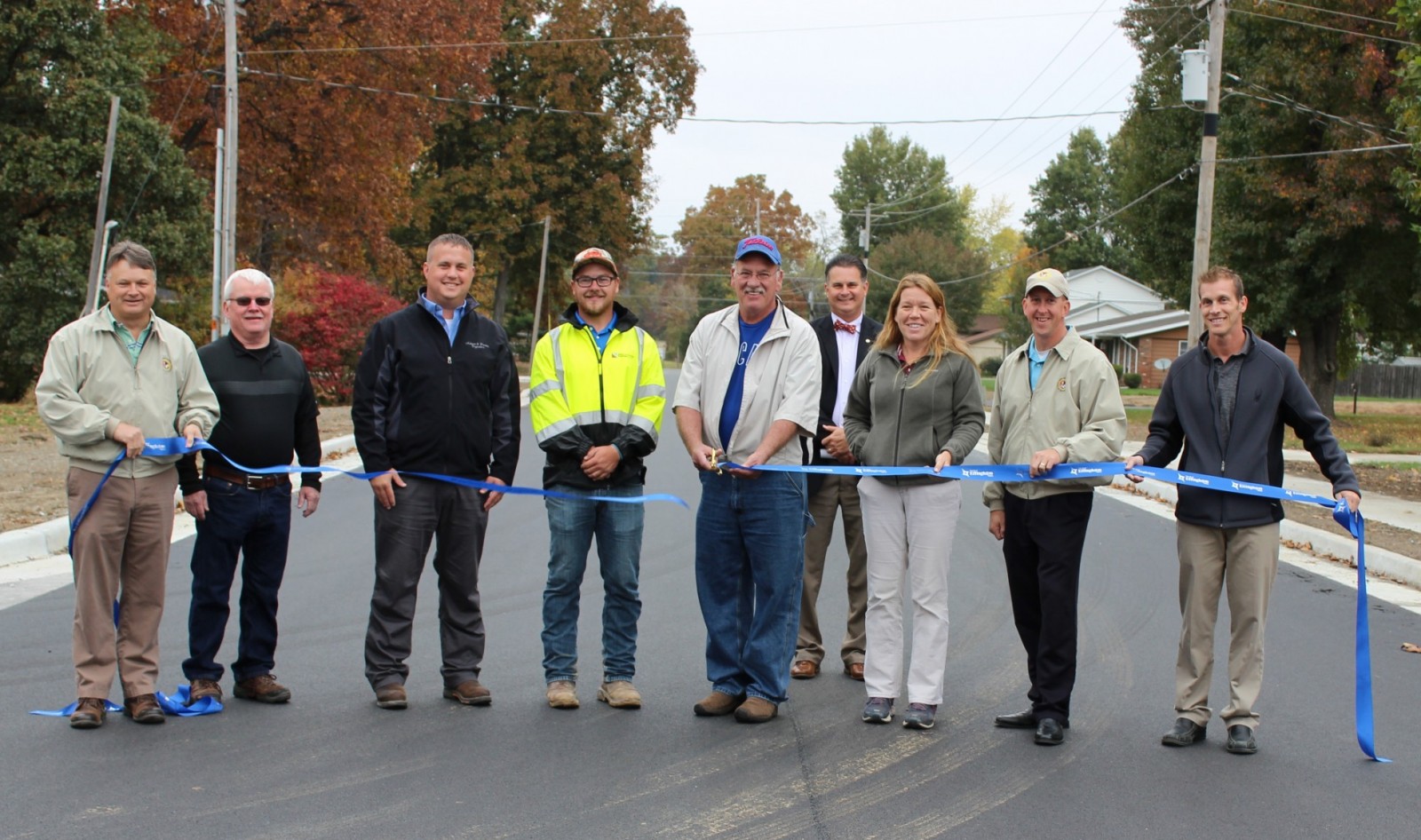 City Officials and Contractors who worked on the N. Raney Street Road Project open the street to through traffic Thursday morning. City Commissioner Don Althoff cut the ribbon. 