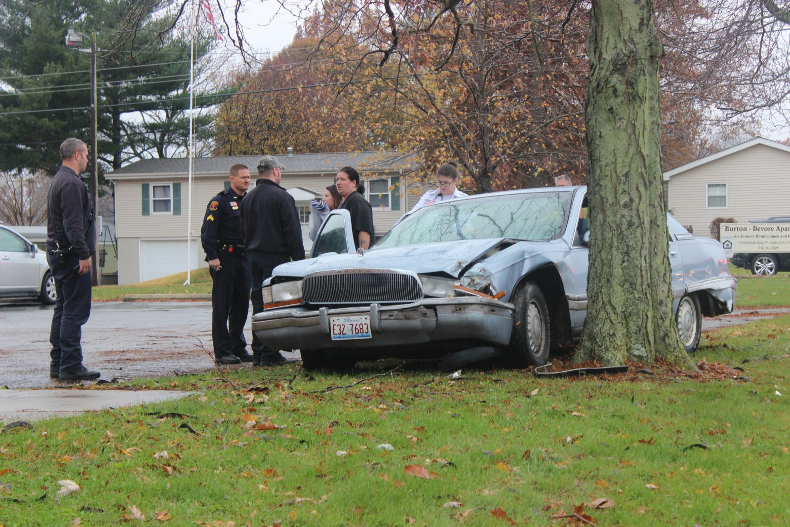 Paramedics and Police inspect a vehicle that collided with a tree on Temple Avenue.